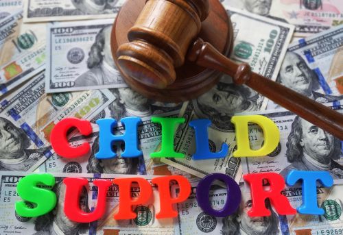 Child Support letters with gavel and cash concept for child sport.