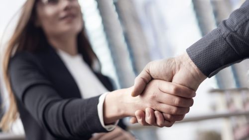 Client and attorney shaking hands concept of attorney retainer.