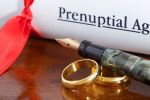 Prenuptial agreement papers with wedding bands - BartonWood