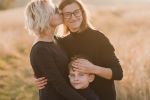 Mothers having fun with their son and pet. Rights of the Non-Biological Parent in Same-Sex Marriage