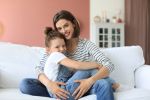 Happy loving mom hugging little daughter, spend time together at home. Concept for when and how to modify child custody.