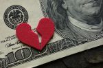 Broken red heart on a hundred dollar bill. Visual concept for a legal blog discussing How high net-worth divorces can be even more complicated than other divorces.