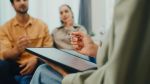 Closeup of young couple in serious discussion with a mediator. Visual concept for a family law blog discussing divorce mediation.